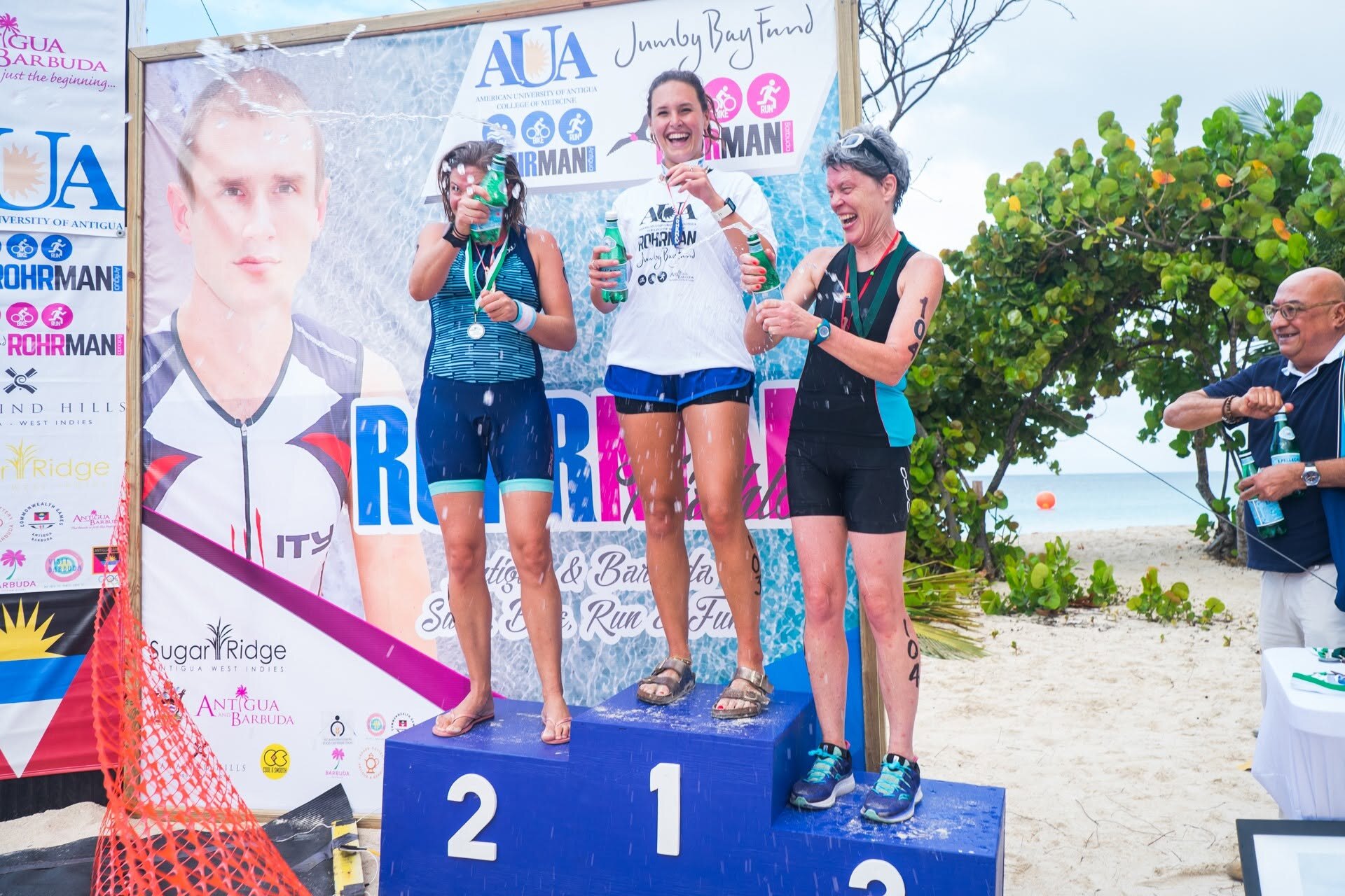 Women celebrating on the AUA Rohrman podium