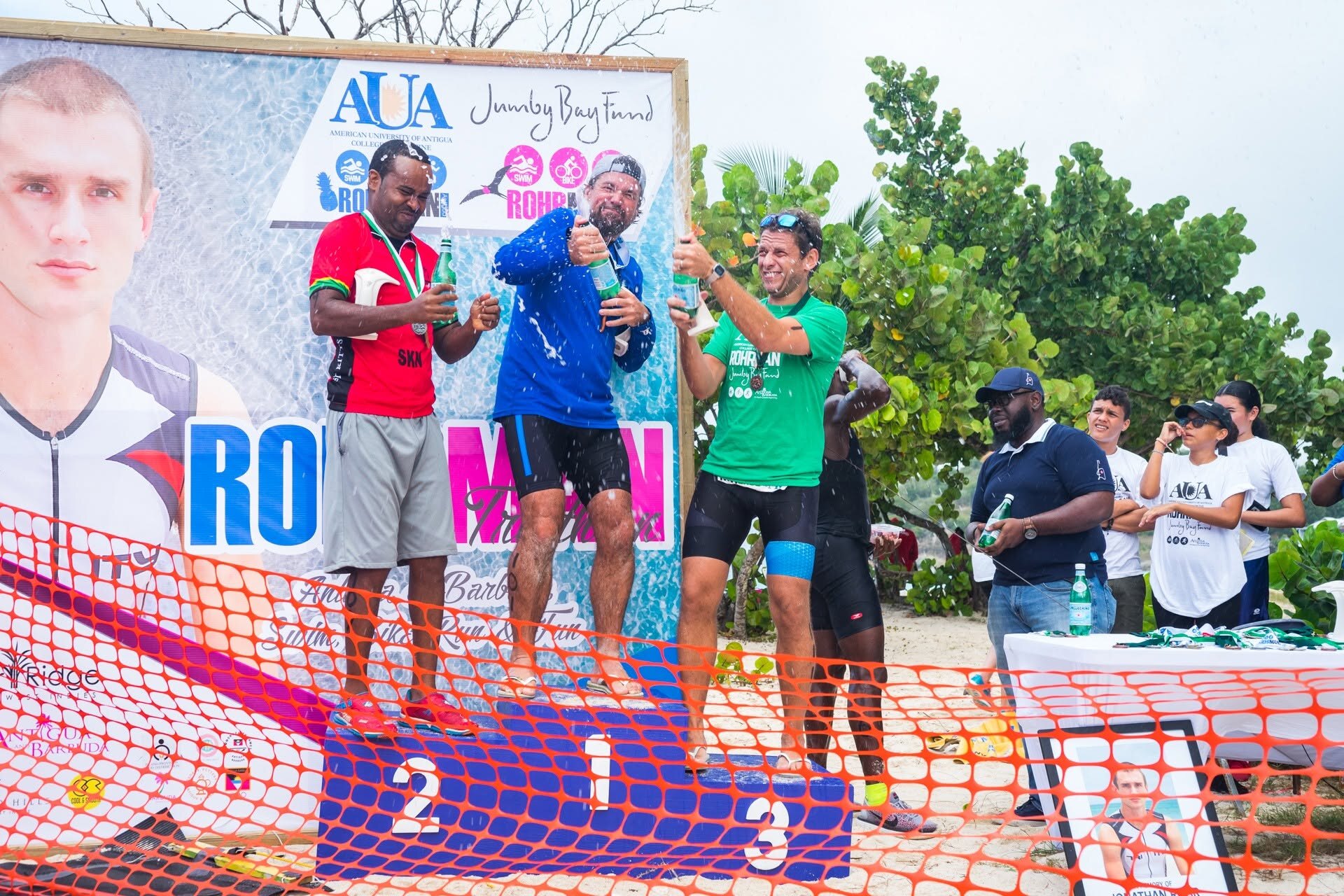 Men celebrating on the AUA Rohrman podium