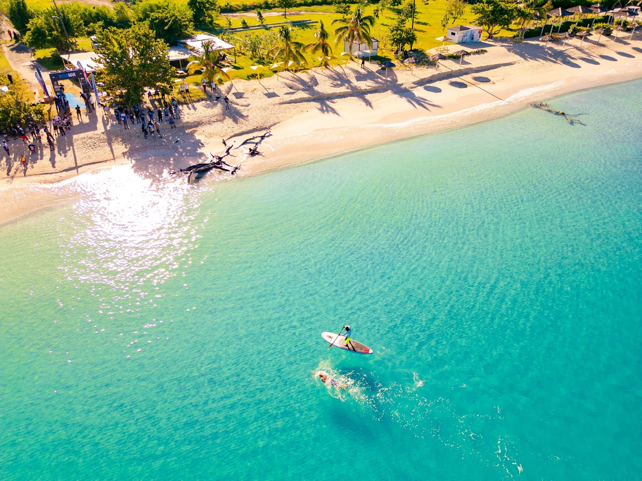 Open-water swimmers crossing Antigua's turquoise sea