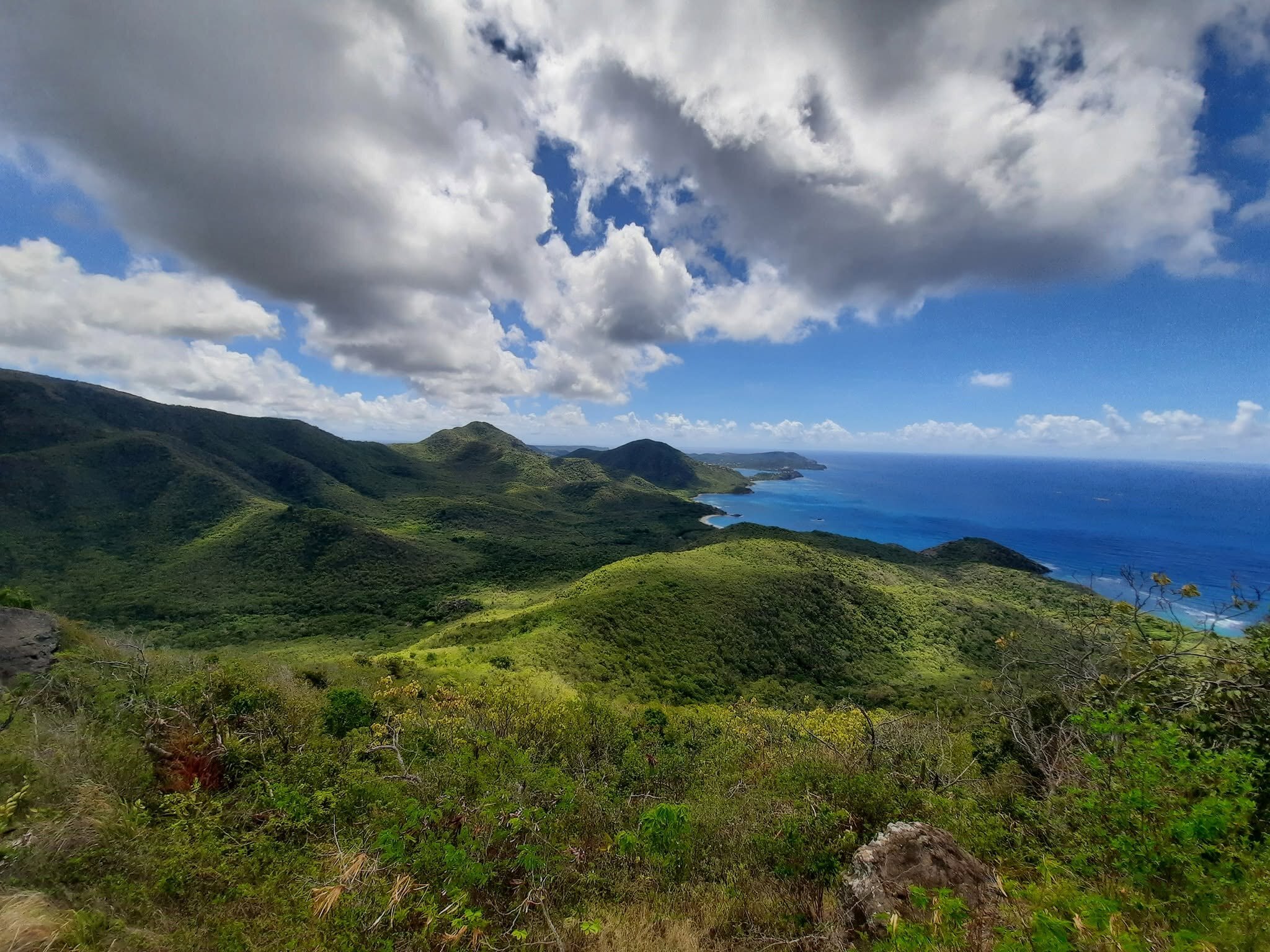 Antigua's rugged green ridgelines beneath dramatic clouds