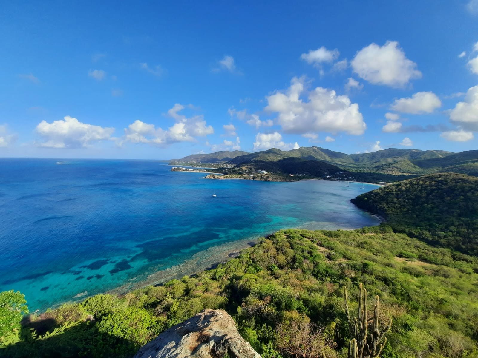 Aerial view across Antigua's coastline and Caribbean sea