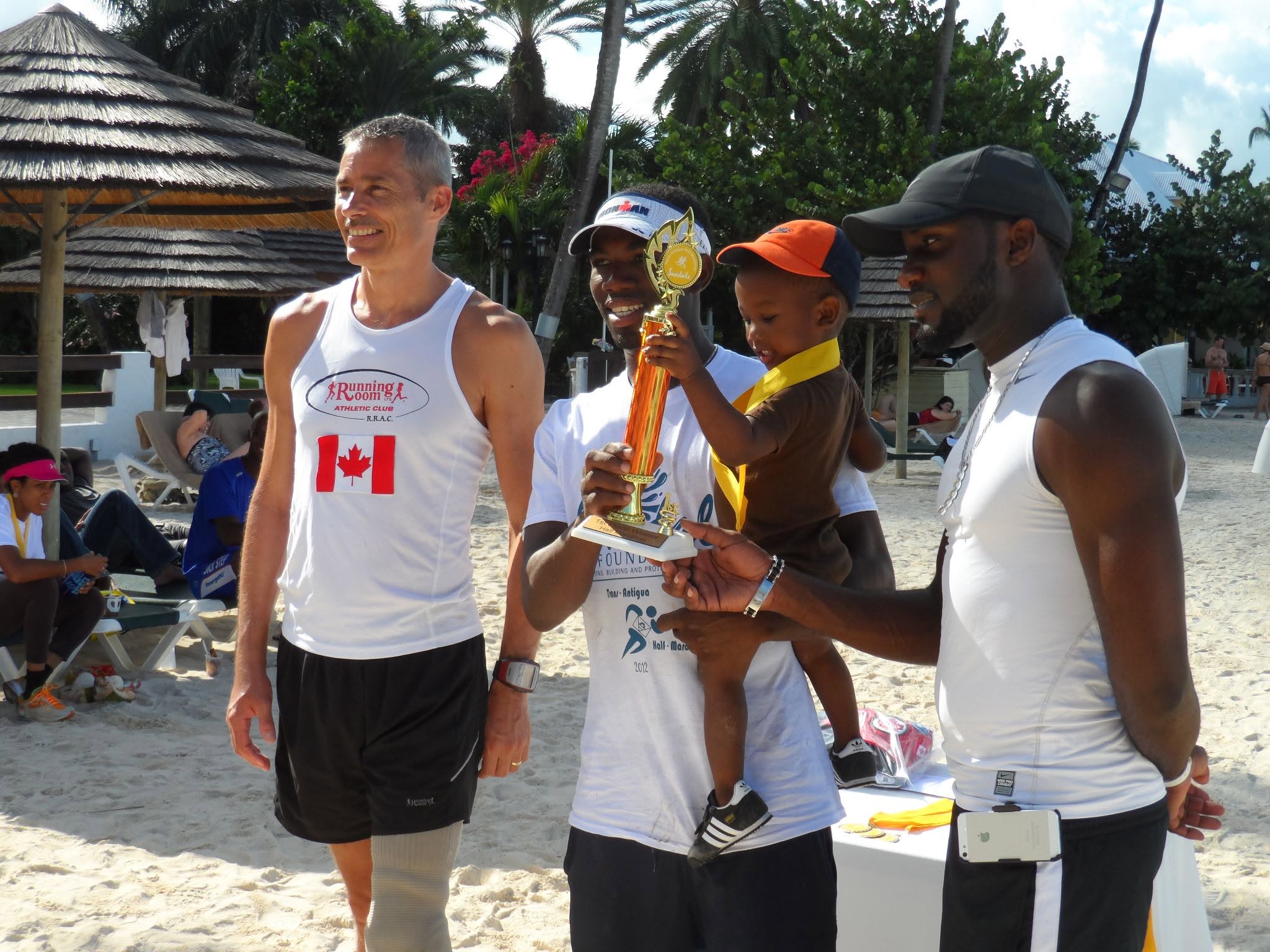 Andre Simon presenting a trophy at a community sporting event
