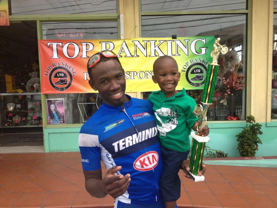Andre Simon sharing a trophy celebration with a young child